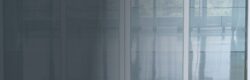Large glass windows with sheer curtains, letting in sunlight; peaceful indoor space ideal for escaping Houston heat before local AC repair service arrives.